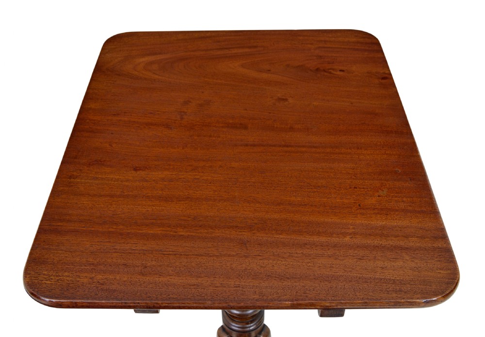 An early 19th-century mahogany tilt-top occasional table featuring a rectangular top, turned baluster stem, and three splayed legs. View VI