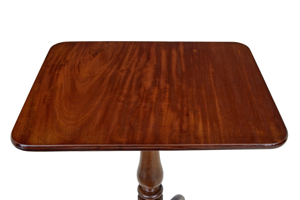 An early 19th-century mahogany tilt-top occasional table featuring a rectangular top, turned baluster stem, and three splayed legs. View VII