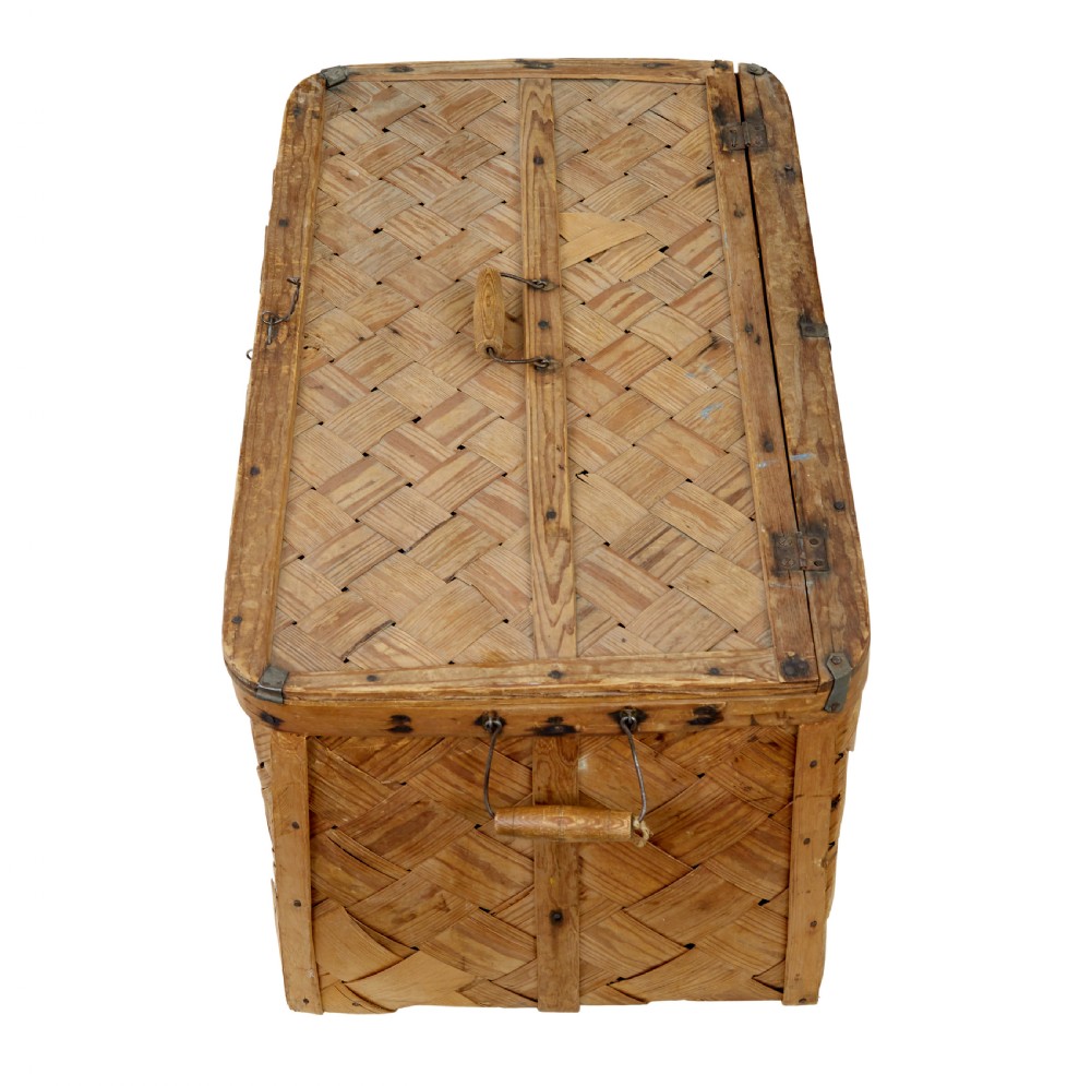 A 19th-century Swedish rectangular storage chest made from woven pine splints with a fitted hinged lid and wooden side handles. View II
