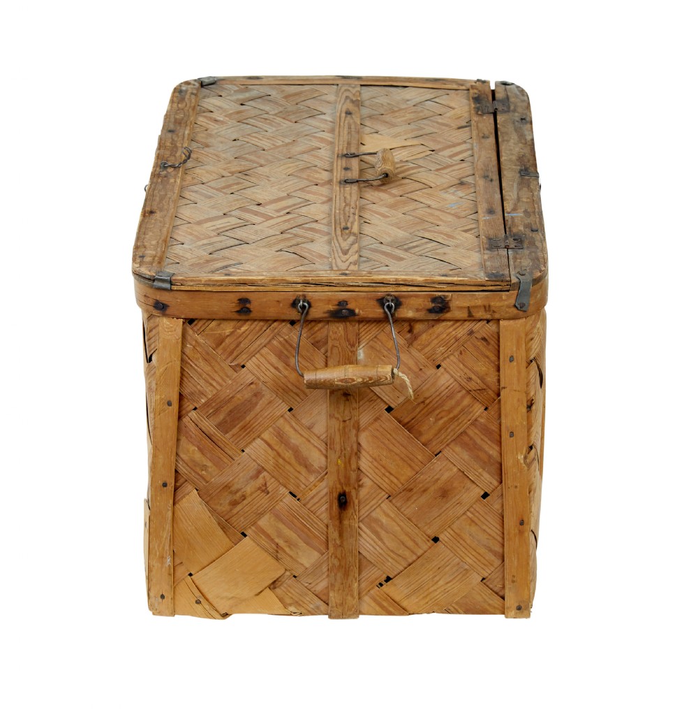A 19th-century Swedish rectangular storage chest made from woven pine splints with a fitted hinged lid and wooden side handles. View V