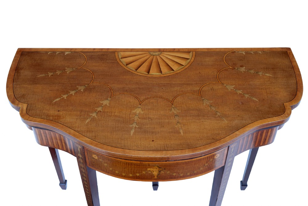A 19th-century Sheraton Revival mahogany card table featuring a demi-lune fold-over top, satinwood marquetry with urn and swag motifs, and four tapered square legs. View III
