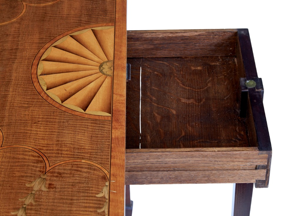 A 19th-century Sheraton Revival mahogany card table featuring a demi-lune fold-over top, satinwood marquetry with urn and swag motifs, and four tapered square legs. View IV