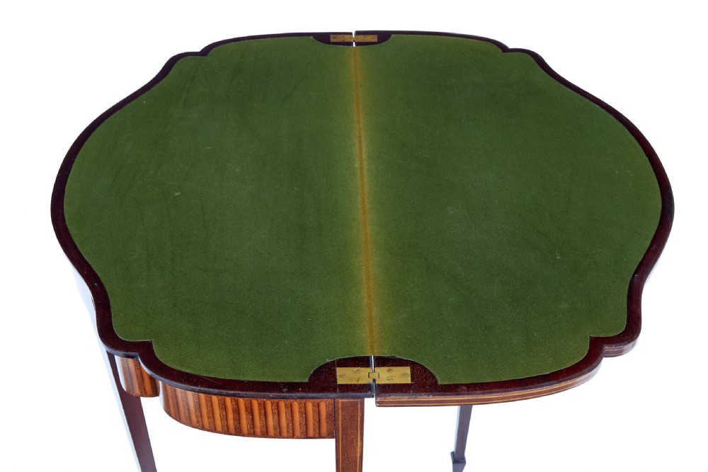 A 19th-century Sheraton Revival mahogany card table featuring a demi-lune fold-over top, satinwood marquetry with urn and swag motifs, and four tapered square legs. View VI