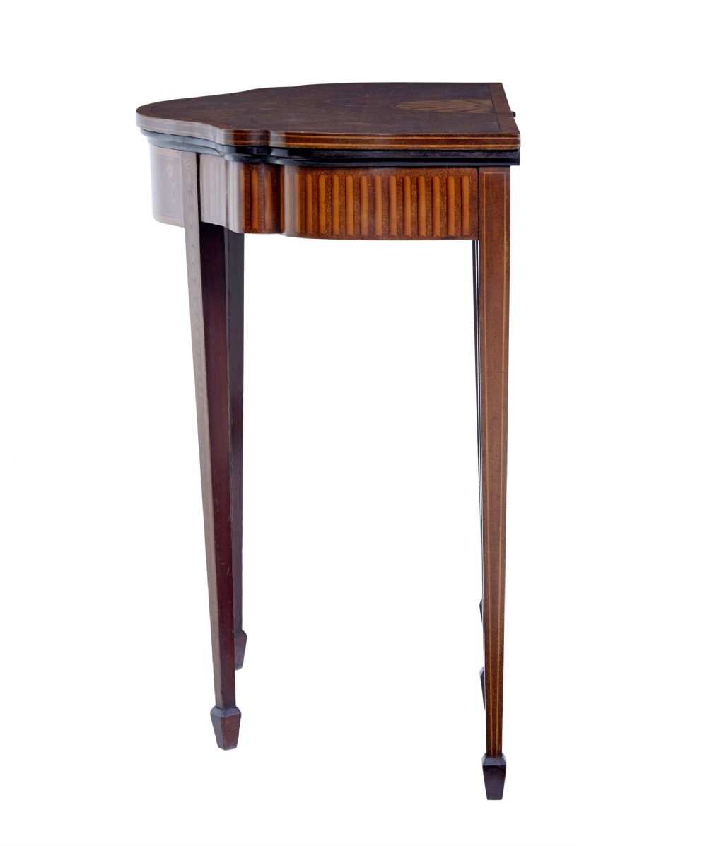 A 19th-century Sheraton Revival mahogany card table featuring a demi-lune fold-over top, satinwood marquetry with urn and swag motifs, and four tapered square legs. View VII