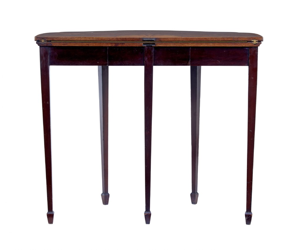 A 19th-century Sheraton Revival mahogany card table featuring a demi-lune fold-over top, satinwood marquetry with urn and swag motifs, and four tapered square legs. View IX