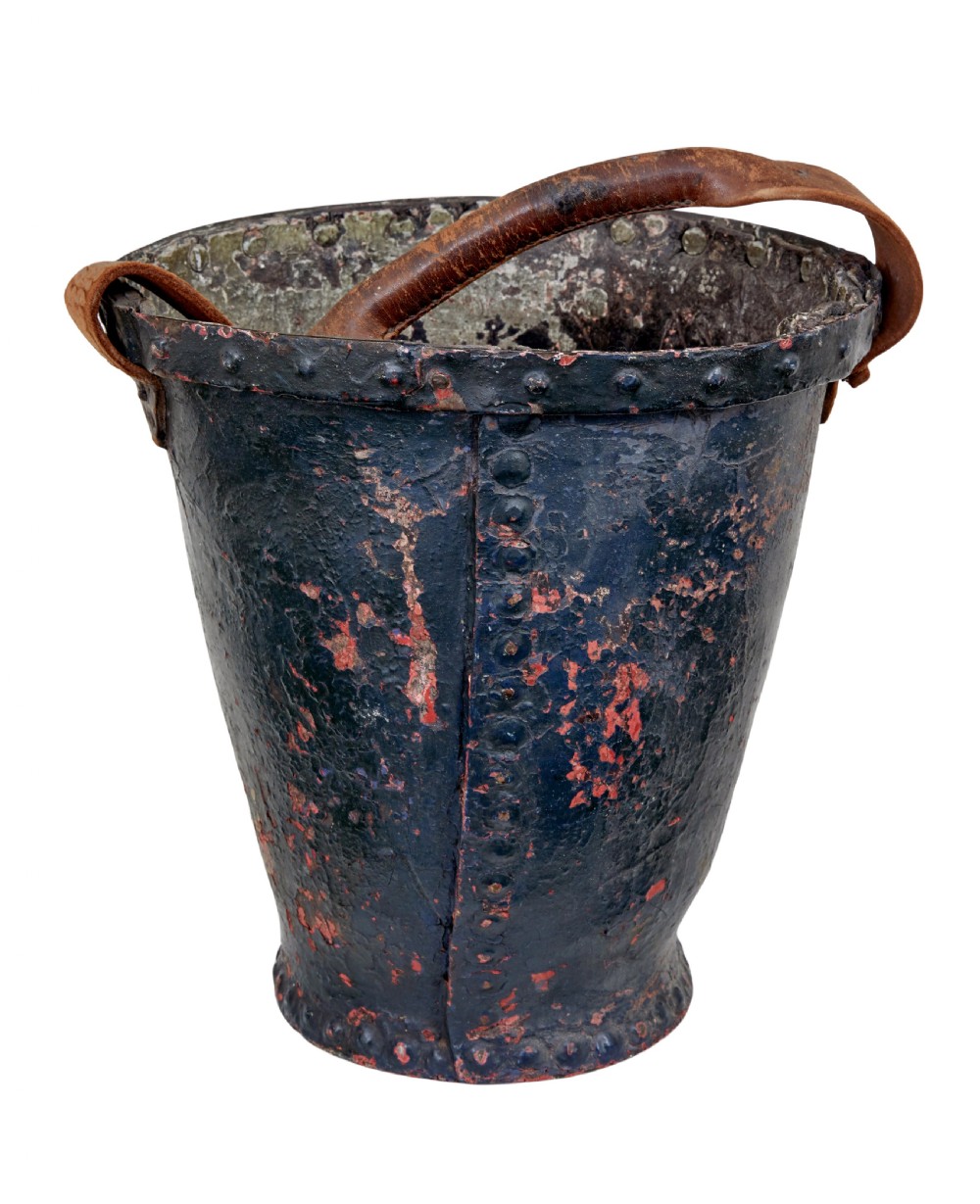 A late eighteenth-century leather fire bucket decorated with a hand-painted royal coat of arms, copper studding around the rim and base, and a thick leather handle. View III
