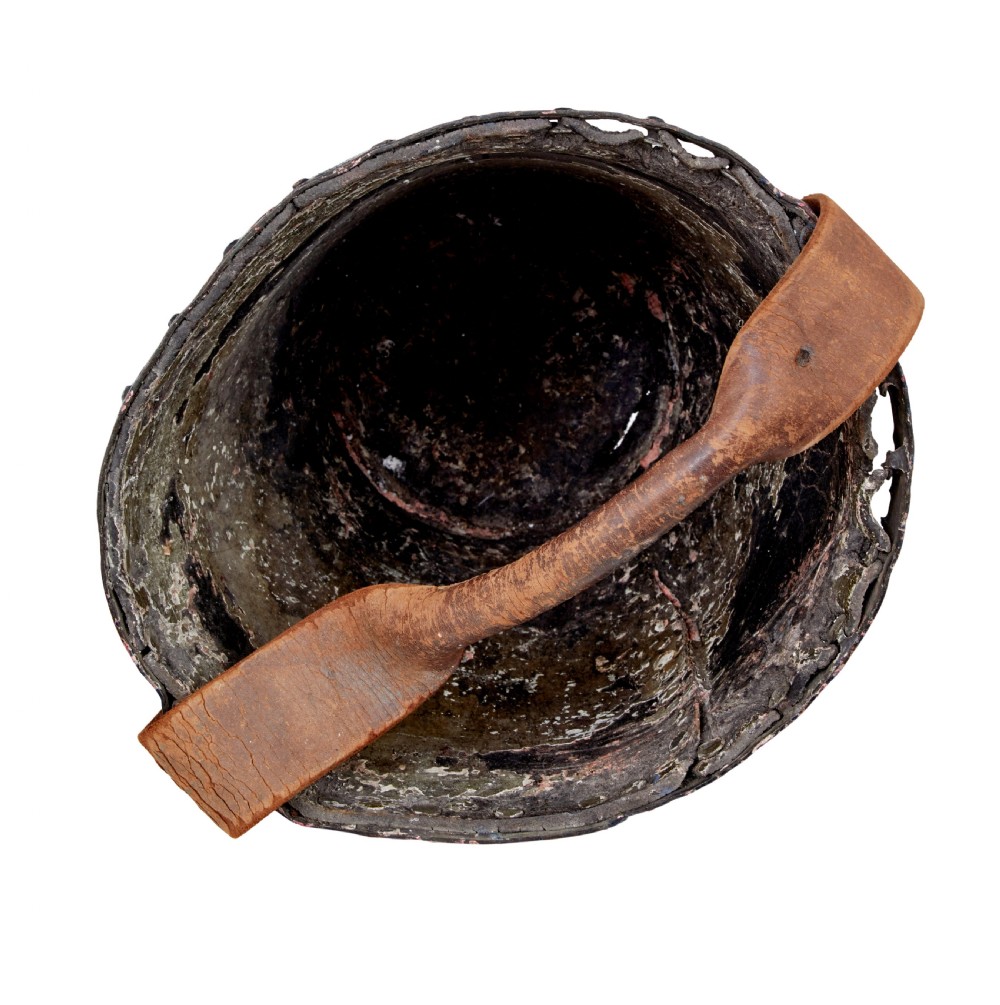 A late eighteenth-century leather fire bucket decorated with a hand-painted royal coat of arms, copper studding around the rim and base, and a thick leather handle. View IV