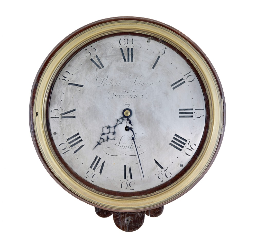 An 18th-century Georgian wall clock featuring an engraved silvered dial with Roman numerals, a brass bezel, and a circular mahogany surround.