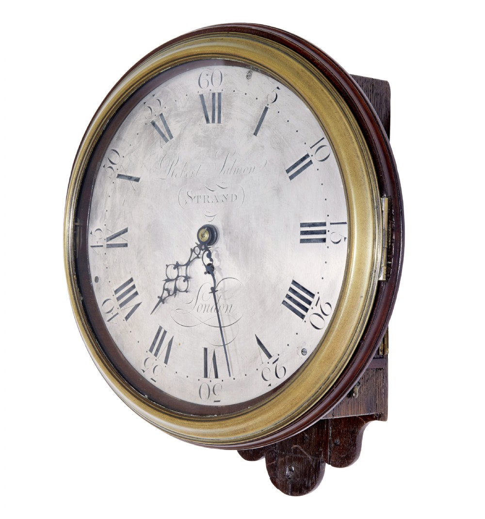 An 18th-century Georgian wall clock featuring an engraved silvered dial with Roman numerals, a brass bezel, and a circular mahogany surround. View II