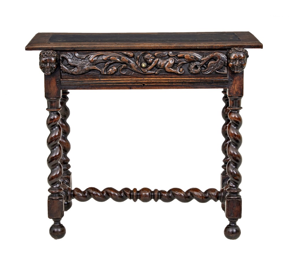 An early 19th-century Flemish carved walnut side table featuring barley twist legs, a carved frieze drawer with corner masks, and a low twist stretcher. View II