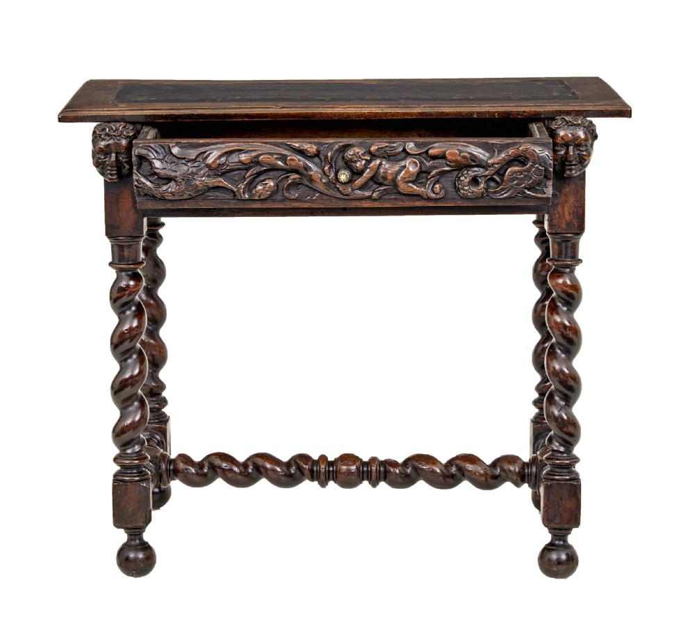 An early 19th-century Flemish carved walnut side table featuring barley twist legs, a carved frieze drawer with corner masks, and a low twist stretcher. View III