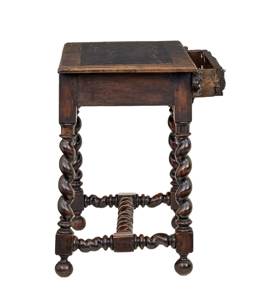 An early 19th-century Flemish carved walnut side table featuring barley twist legs, a carved frieze drawer with corner masks, and a low twist stretcher. View IV