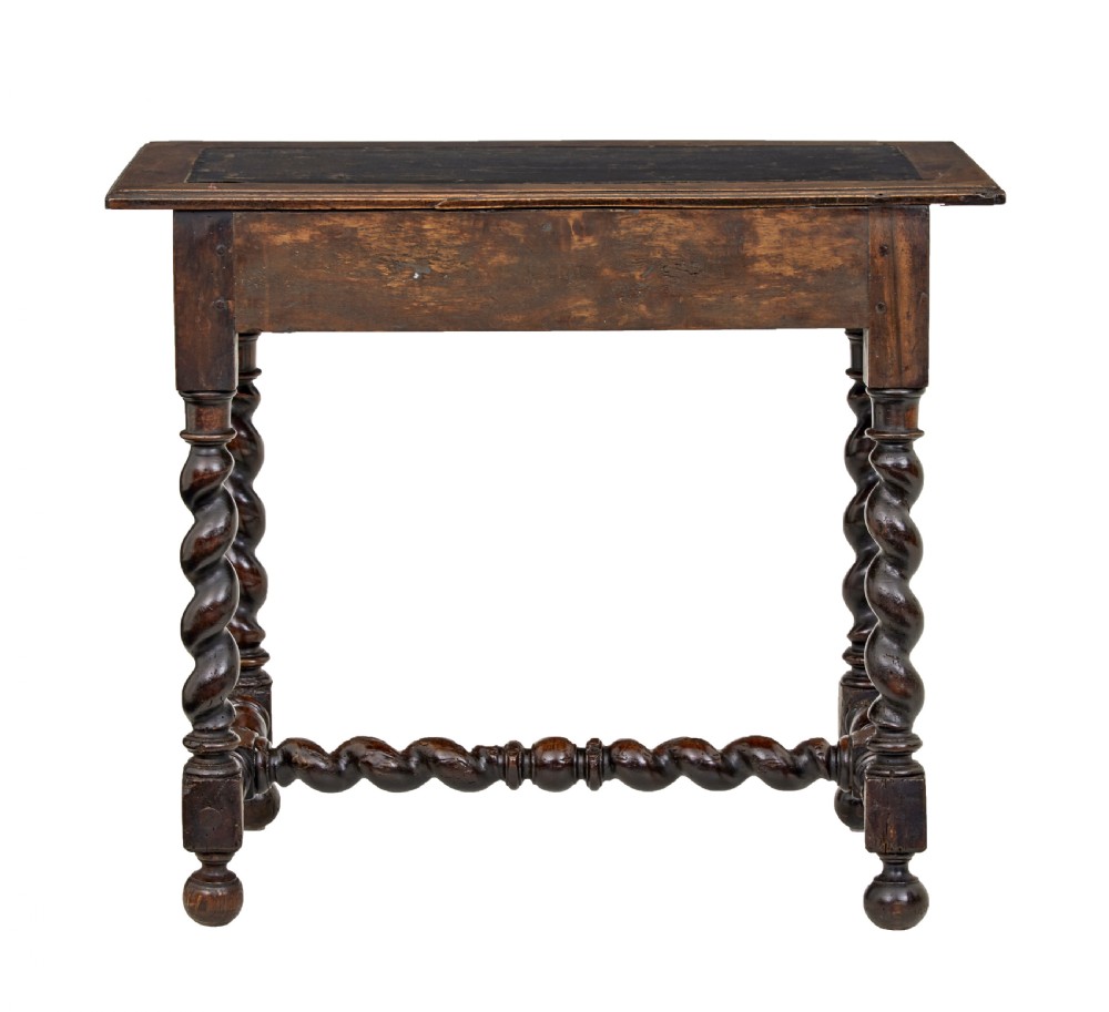 An early 19th-century Flemish carved walnut side table featuring barley twist legs, a carved frieze drawer with corner masks, and a low twist stretcher. View V