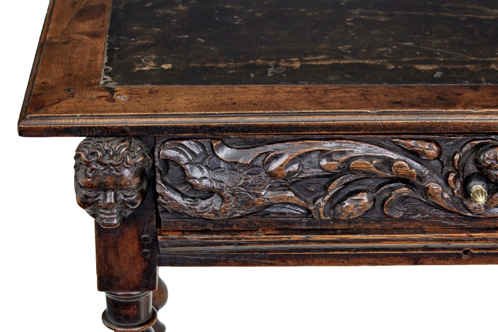 An early 19th-century Flemish carved walnut side table featuring barley twist legs, a carved frieze drawer with corner masks, and a low twist stretcher. View IX