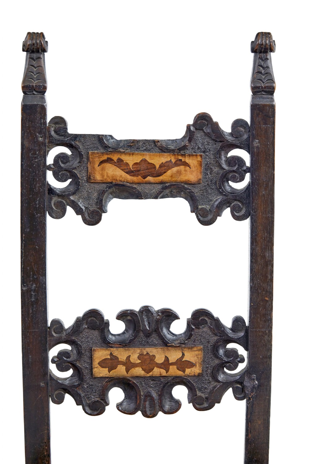 A pair of 19th-century dark oak Carolean-inspired hall chairs featuring intricate scrollwork carving, inlaid back panels, and turned finials. View VII