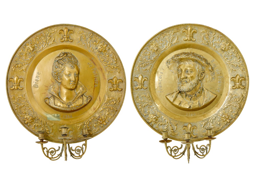 A pair of circular 19th-century French brass wall sconces featuring central relief portraits of Diane de Poitiers and King Francois I, adorned with fleur-de-lis motifs and three candle branches each.