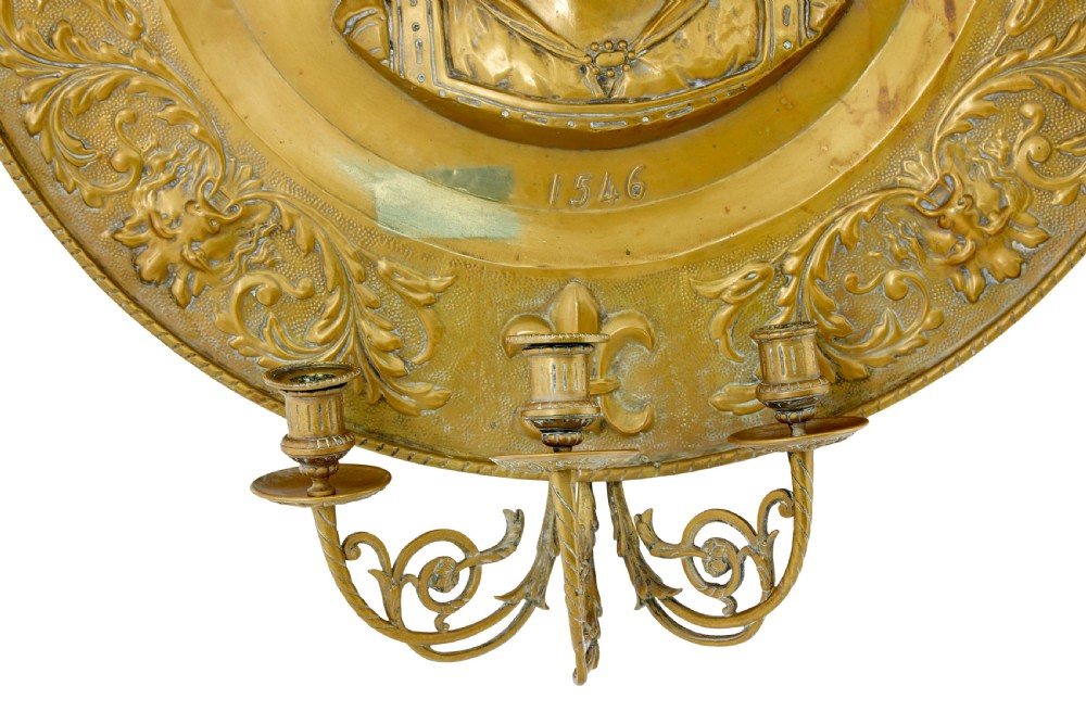 A pair of circular 19th-century French brass wall sconces featuring central relief portraits of Diane de Poitiers and King Francois I, adorned with fleur-de-lis motifs and three candle branches each. View IV