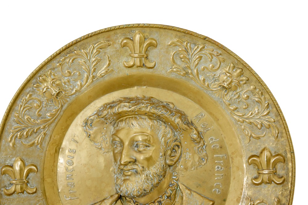 A pair of circular 19th-century French brass wall sconces featuring central relief portraits of Diane de Poitiers and King Francois I, adorned with fleur-de-lis motifs and three candle branches each. View VI