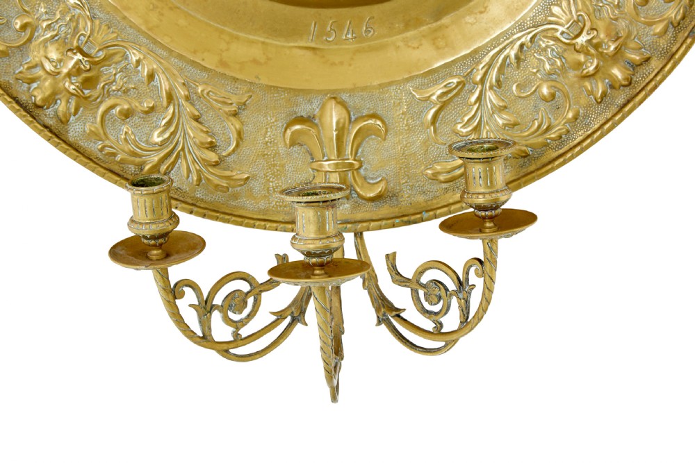 A pair of circular 19th-century French brass wall sconces featuring central relief portraits of Diane de Poitiers and King Francois I, adorned with fleur-de-lis motifs and three candle branches each. View VII