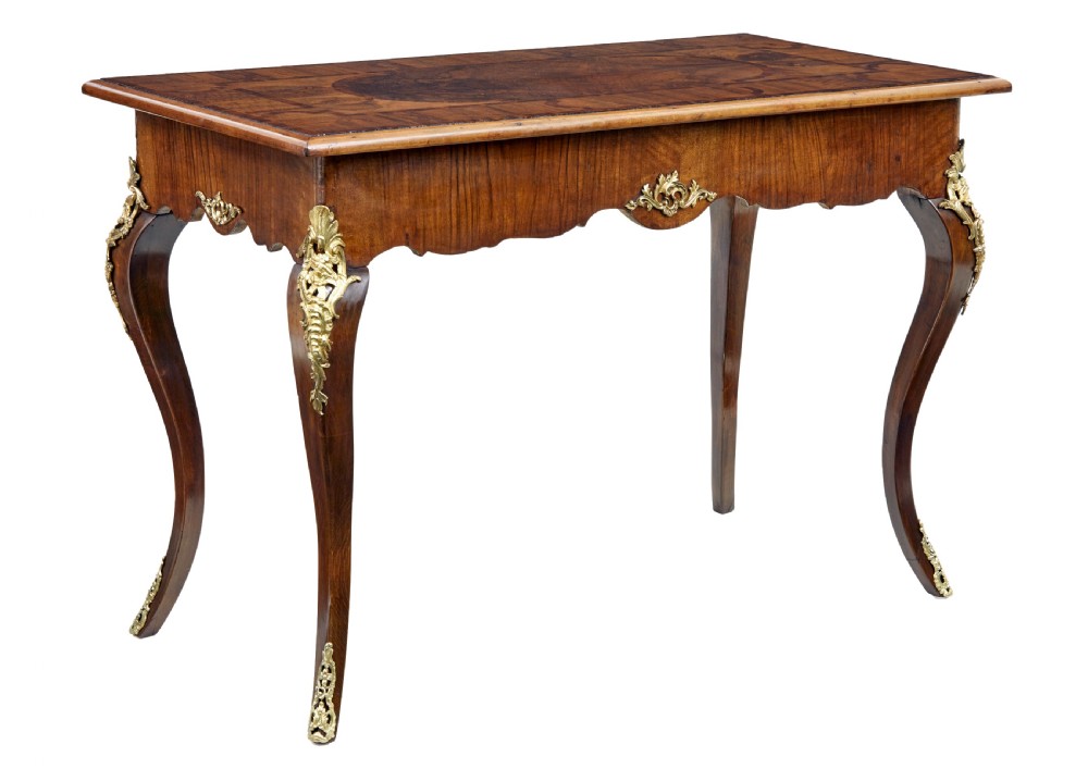 A 19th-century Rococo Revival walnut side table featuring inlaid marquetry on the top, curved cabriole legs, and ornate gilt-bronze ormolu mounts.