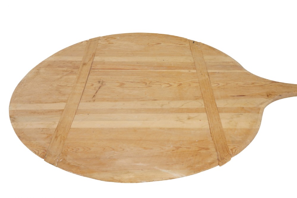 A large 19th-century Scandinavian pine baker peel with a long slender handle and a wide circular paddle head. View V