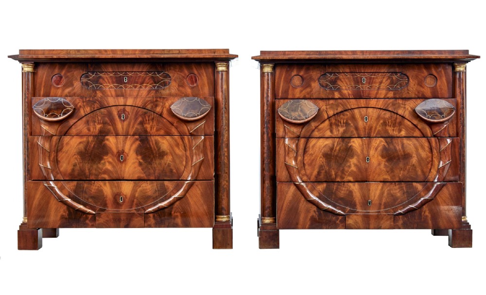A matching pair of early nineteenth-century mahogany Biedermeier commodes featuring carved cornucopia motifs and side columns. View III