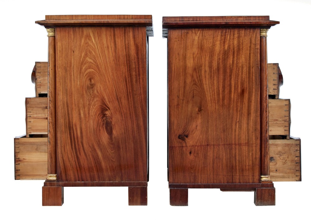 A matching pair of early nineteenth-century mahogany Biedermeier commodes featuring carved cornucopia motifs and side columns. View IV