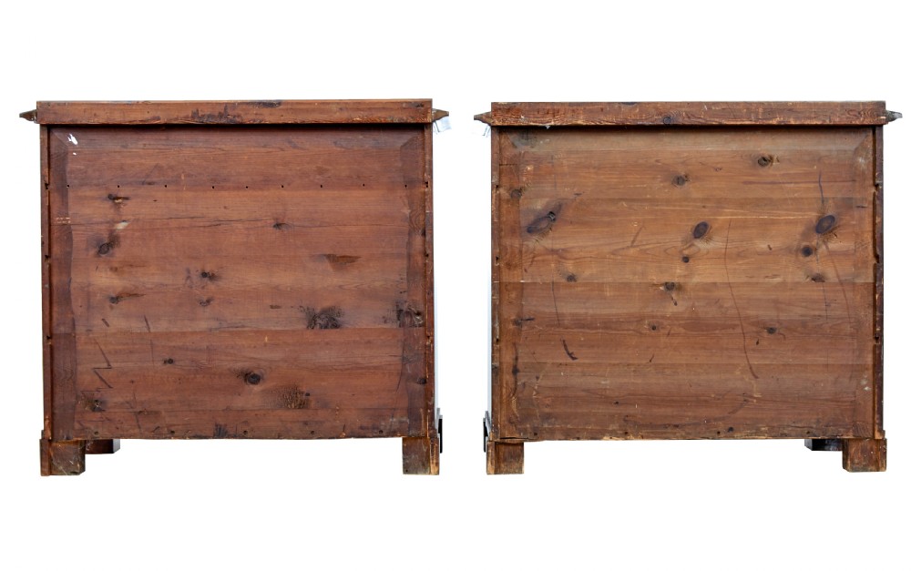 A matching pair of early nineteenth-century mahogany Biedermeier commodes featuring carved cornucopia motifs and side columns. View V