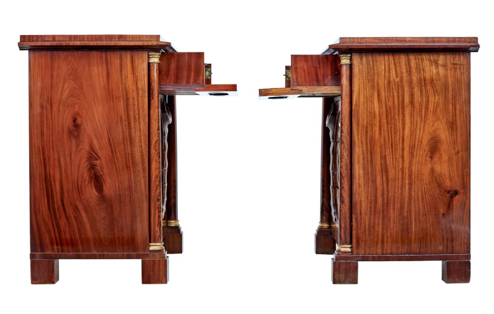 A matching pair of early nineteenth-century mahogany Biedermeier commodes featuring carved cornucopia motifs and side columns. View VI