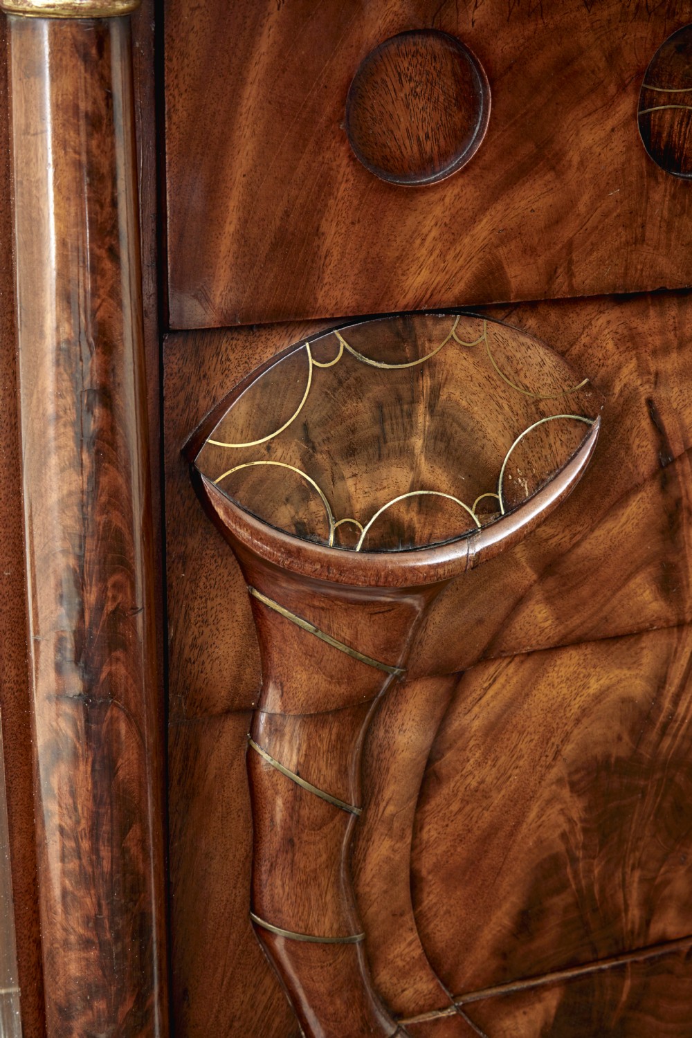 A matching pair of early nineteenth-century mahogany Biedermeier commodes featuring carved cornucopia motifs and side columns. View VII