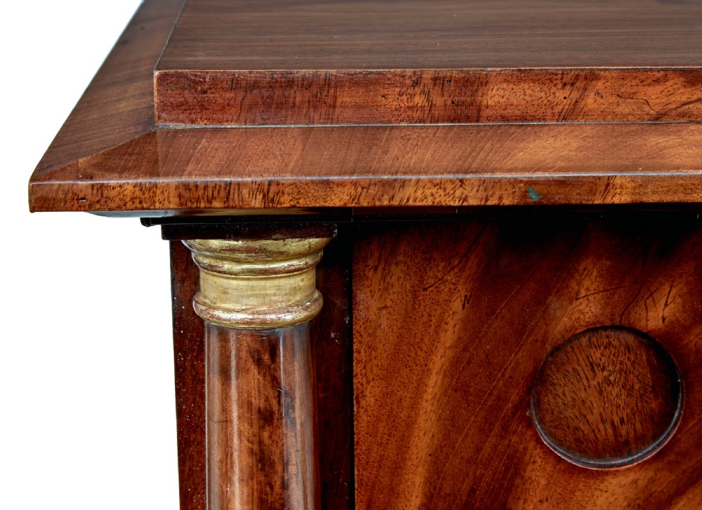 A matching pair of early nineteenth-century mahogany Biedermeier commodes featuring carved cornucopia motifs and side columns. View XII