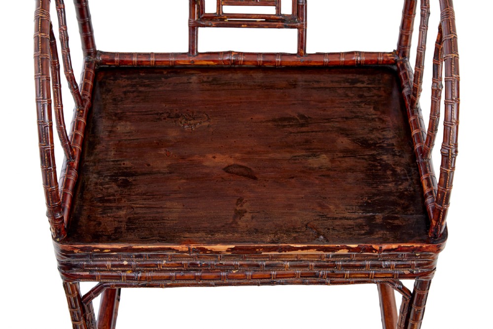 A pair of 19th-century dark brown bamboo armchairs featuring rounded crest rails, geometric lattice splats, and woven panel seats. View II