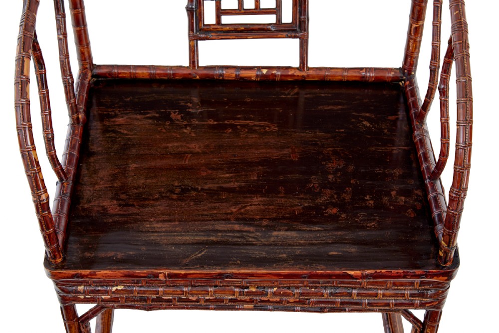 A pair of 19th-century dark brown bamboo armchairs featuring rounded crest rails, geometric lattice splats, and woven panel seats. View III