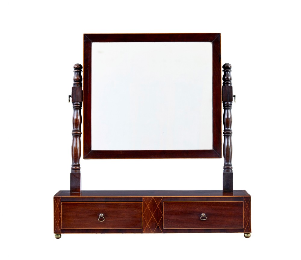 An antique Victorian mahogany toilet mirror with a rectangular tilting glass plate supported by turned upright pillars above a two-drawer inlaid base. View II