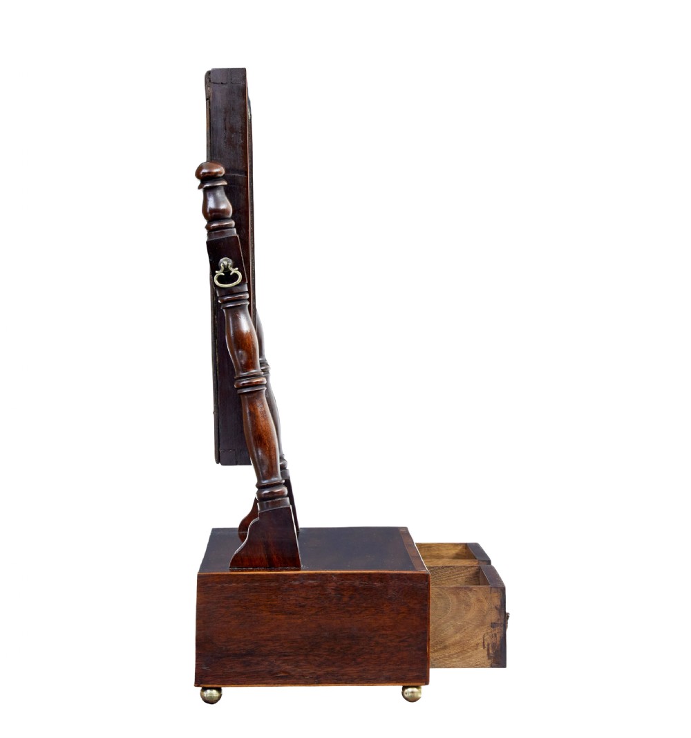 An antique Victorian mahogany toilet mirror with a rectangular tilting glass plate supported by turned upright pillars above a two-drawer inlaid base. View III
