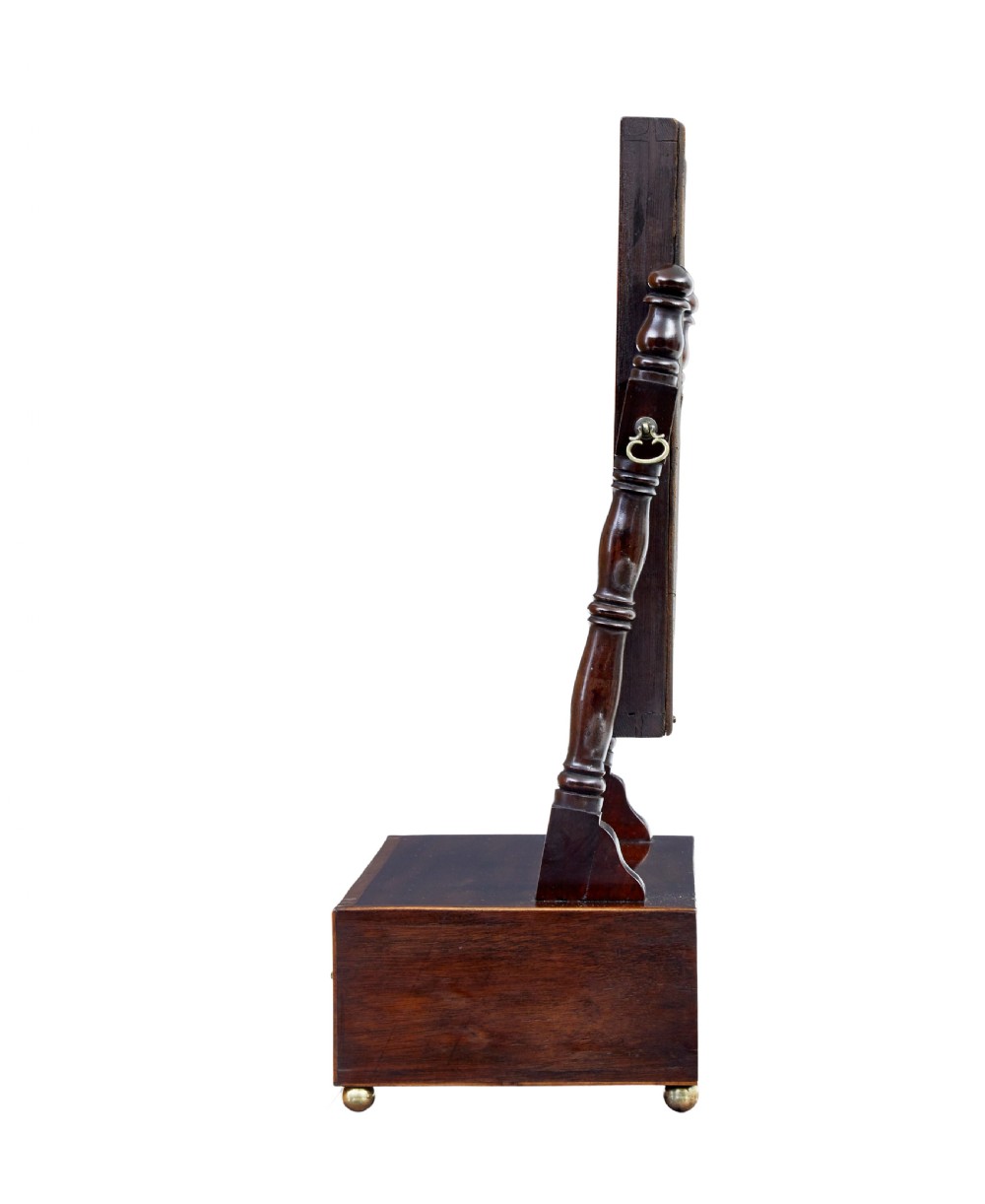 An antique Victorian mahogany toilet mirror with a rectangular tilting glass plate supported by turned upright pillars above a two-drawer inlaid base. View IV