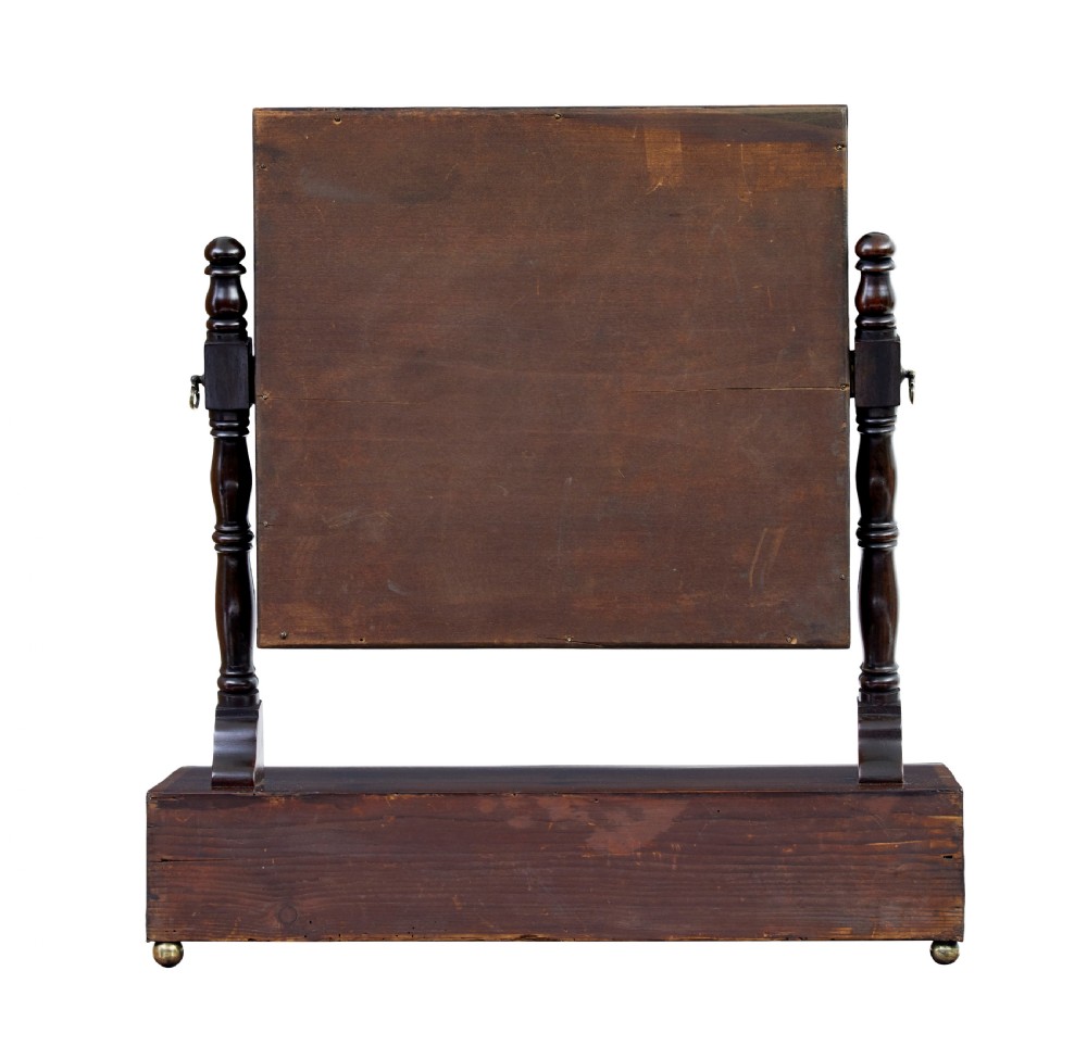 An antique Victorian mahogany toilet mirror with a rectangular tilting glass plate supported by turned upright pillars above a two-drawer inlaid base. View V