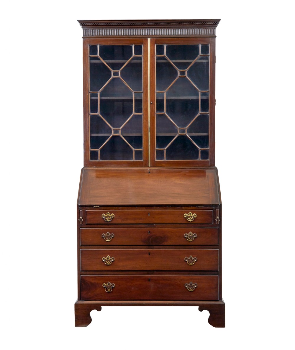 An early nineteenth-century mahogany bureau bookcase featuring upper astragal glazed doors, a slant fall-front writing section, and four graduated lower drawers. View II