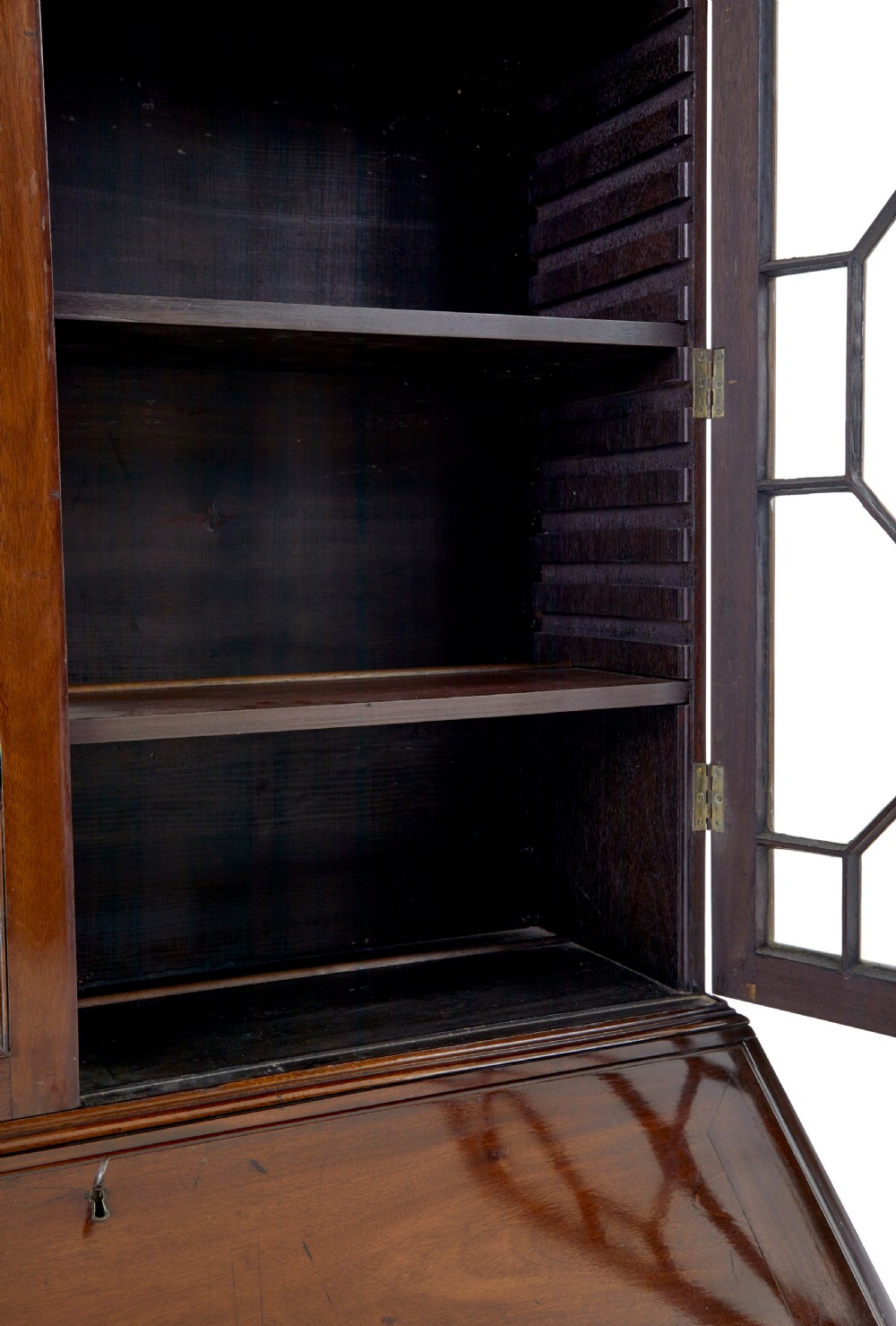 An early nineteenth-century mahogany bureau bookcase featuring upper astragal glazed doors, a slant fall-front writing section, and four graduated lower drawers. View IX