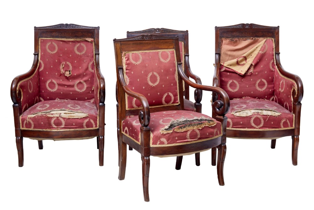 A set of four mid-19th-century Danish mahogany armchairs with scroll arms and red patterned fabric upholstery.