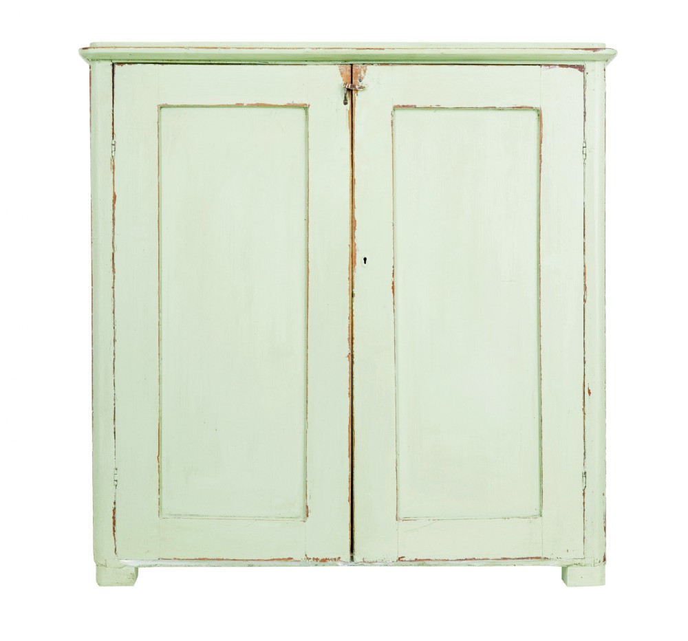 A mid-nineteenth-century Swedish pine cupboard featuring two recessed panel doors painted in distressed pale green with exposed iron hardware.