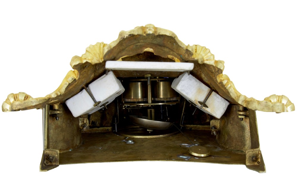 A 19th-century French gilt bronze ormolu mantel clock featuring a knight figure holding a shield and flag above a white enamel Roman numeral dial set into a scrolled base. View XI
