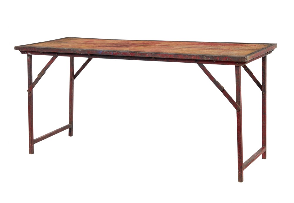 A rectangular folding table featuring a weathered wood top set within a distressed red-painted metal frame and leg structure.