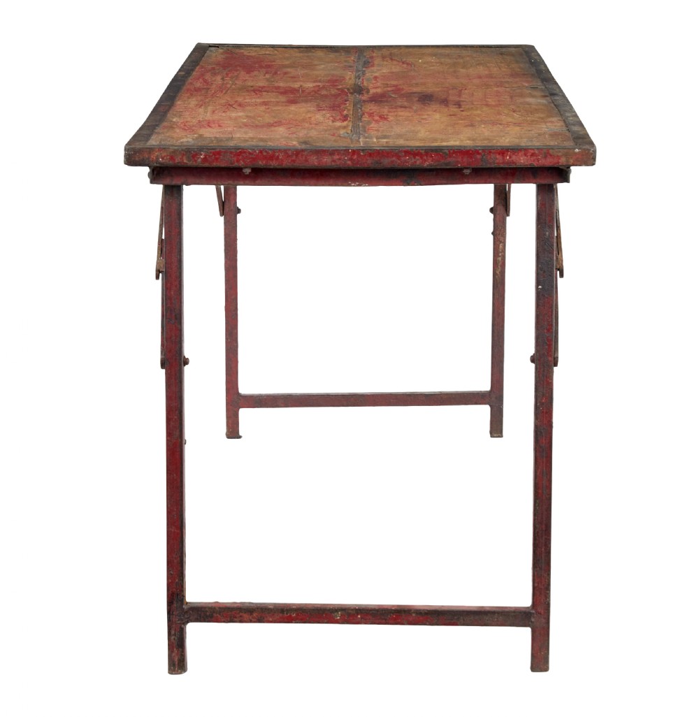 A rectangular folding table featuring a weathered wood top set within a distressed red-painted metal frame and leg structure. View IV