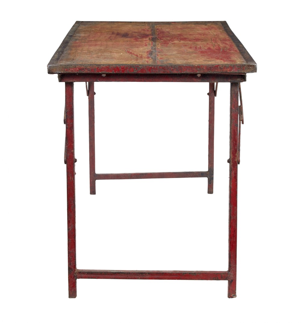 A rectangular folding table featuring a weathered wood top set within a distressed red-painted metal frame and leg structure. View V