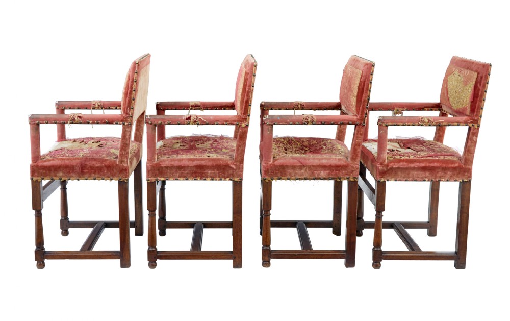 A set of 19th-century carved walnut armchairs with worn red velvet upholstery and embroidered decorative backrest panels. View II
