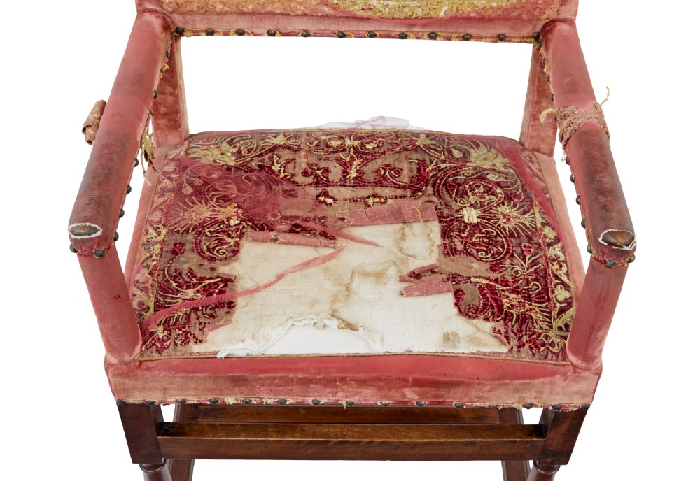 A set of 19th-century carved walnut armchairs with worn red velvet upholstery and embroidered decorative backrest panels. View VI