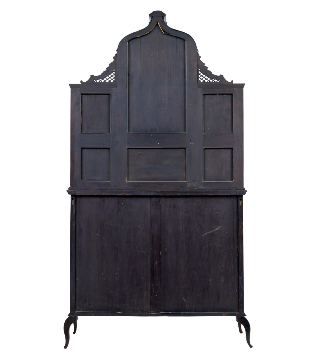 An Edwardian Chippendale Revival dark mahogany display cabinet featuring a multi-paneled mirrored upper section, carved crest, fretwork, and glazed side doors on cabriole legs. View IV
