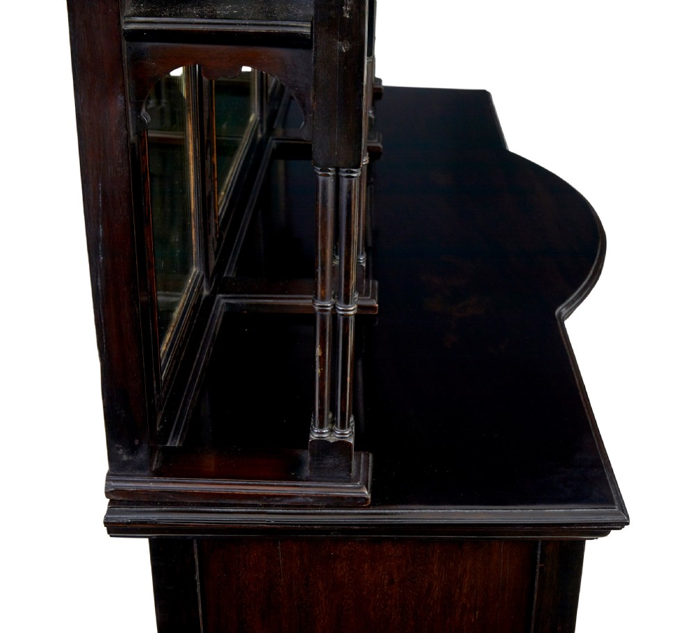 An Edwardian Chippendale Revival dark mahogany display cabinet featuring a multi-paneled mirrored upper section, carved crest, fretwork, and glazed side doors on cabriole legs. View VI