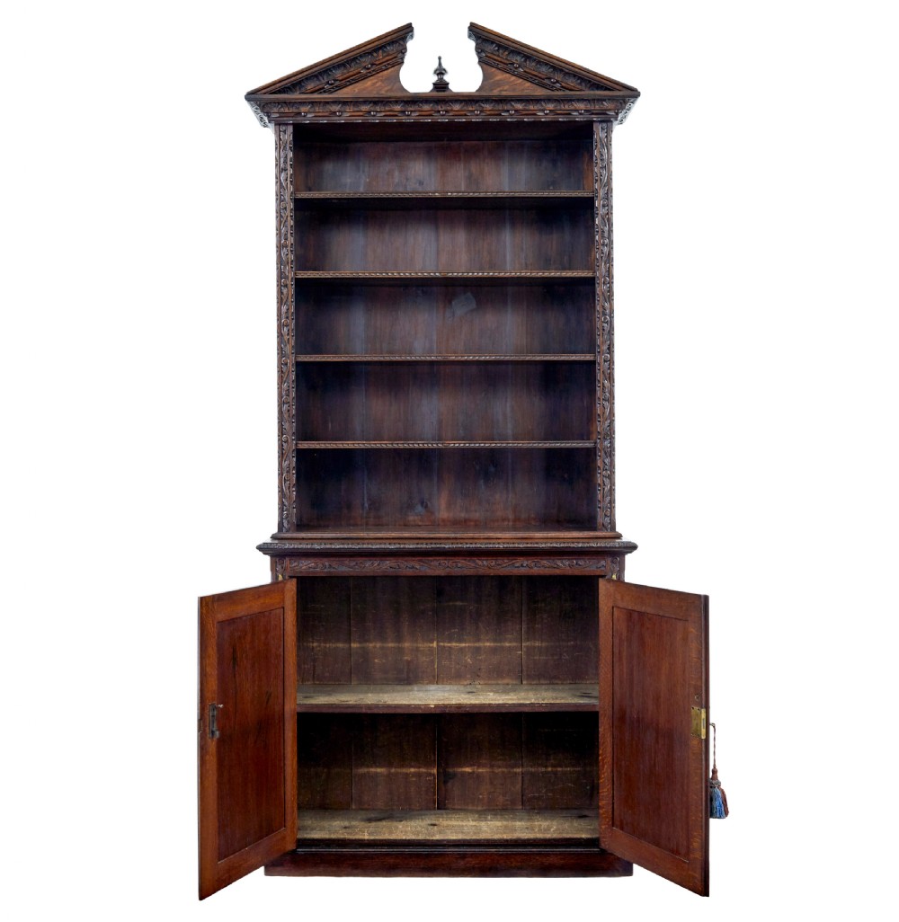 A 19th-century dark oak architectural cabinet featuring an open upper shelf section with a broken pediment crown and lower cupboard doors adorned with floral marquetry inlay. View II